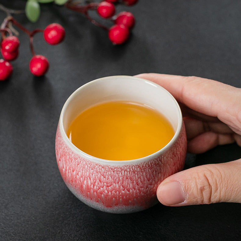 Set of four small ceramic tea cups for sale, each with a different glaze finish.
