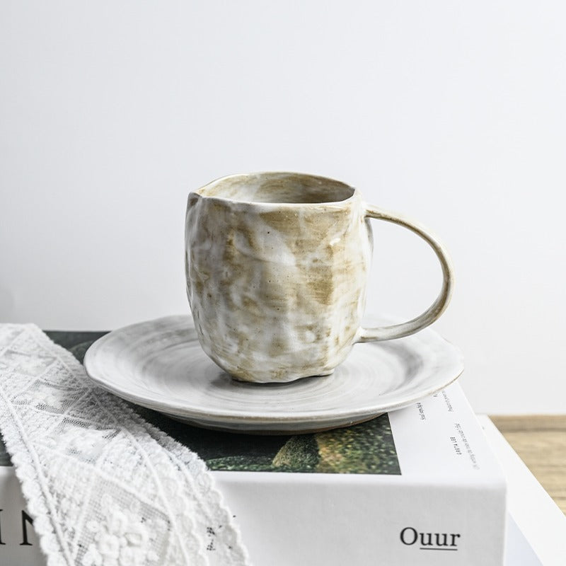 Ceramic tea mug with infuser and lid on a work desk