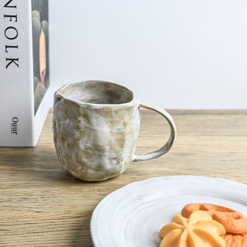 Ceramic tea mug with infuser and lid on a work desk
