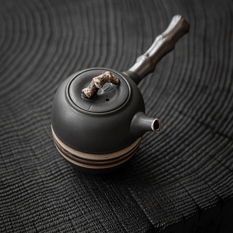 Close-up view of the wabi-sabi teapots black and white texture with bamboo handle