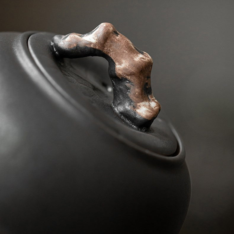 Elegant presentation of the ceramic teapot filled with steaming tea on a wooden table