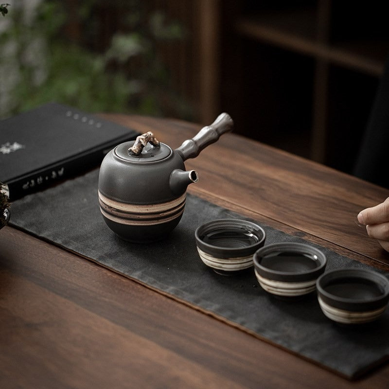 Side angle of the bamboo handle teapot highlighting its minimalist design and craftsmanship