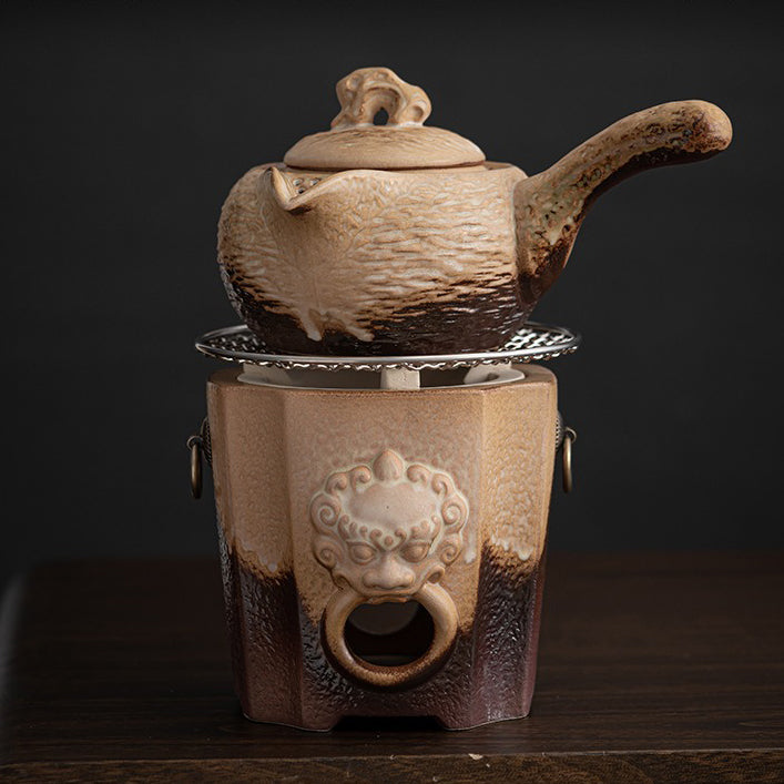 Close-up of the heated teapot showcasing its stone-like texture and ergonomic handle.