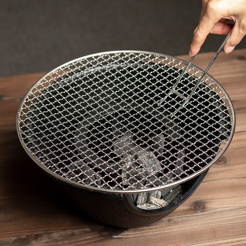 Wood burning tea stove in action, showcasing its ability to brew tea over an open flame.