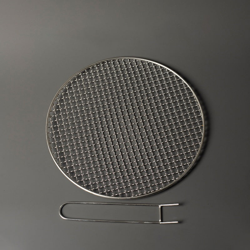 Ceramic pot from the tea cooker set filled with fresh tea leaves, emphasizing its large capacity.