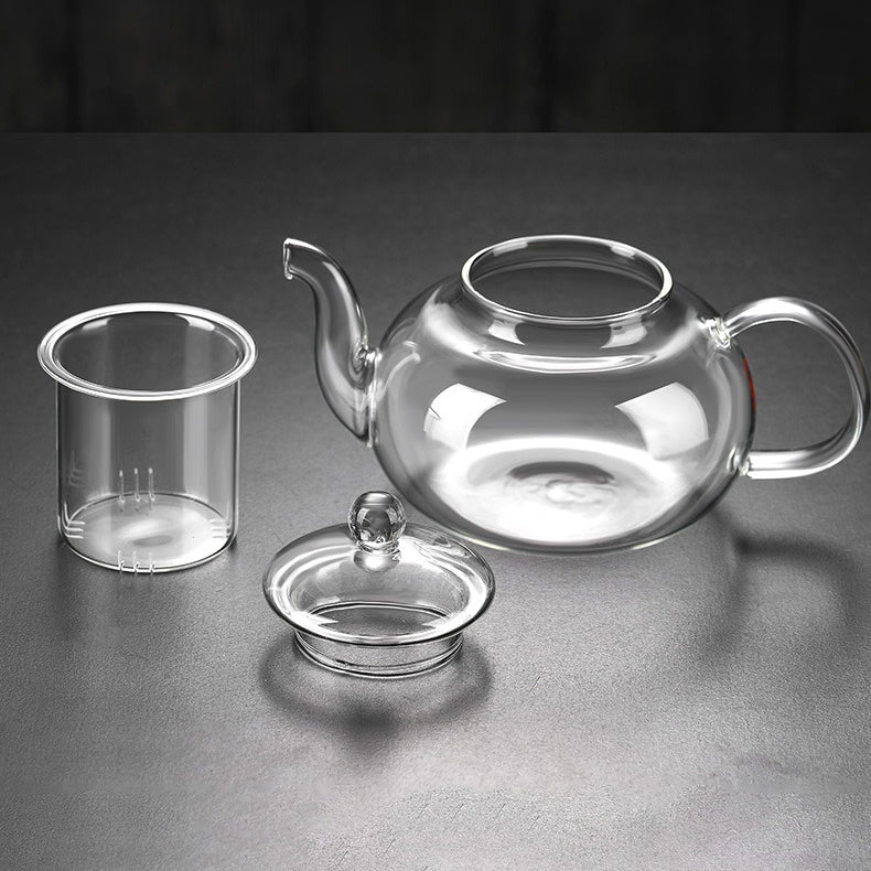 Pouring hot herbal tea from the glass teapot with a smooth spout, highlighting its elegant design