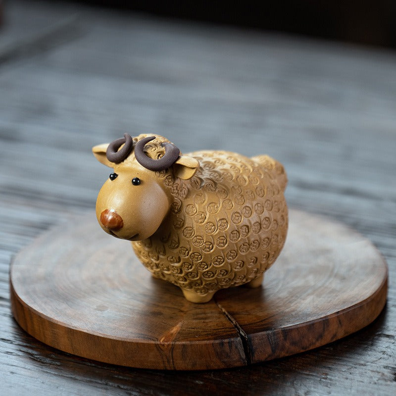Handcrafted Yixing clay sheep tea pet with detailed facial features and textured hair, ideal for tea lovers