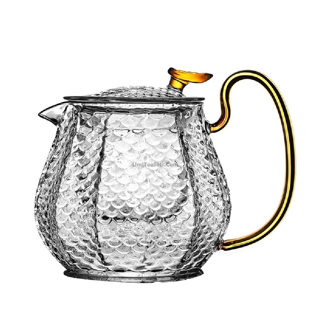 Close-up of colorful handle glass teapot with infuser for flowering tea