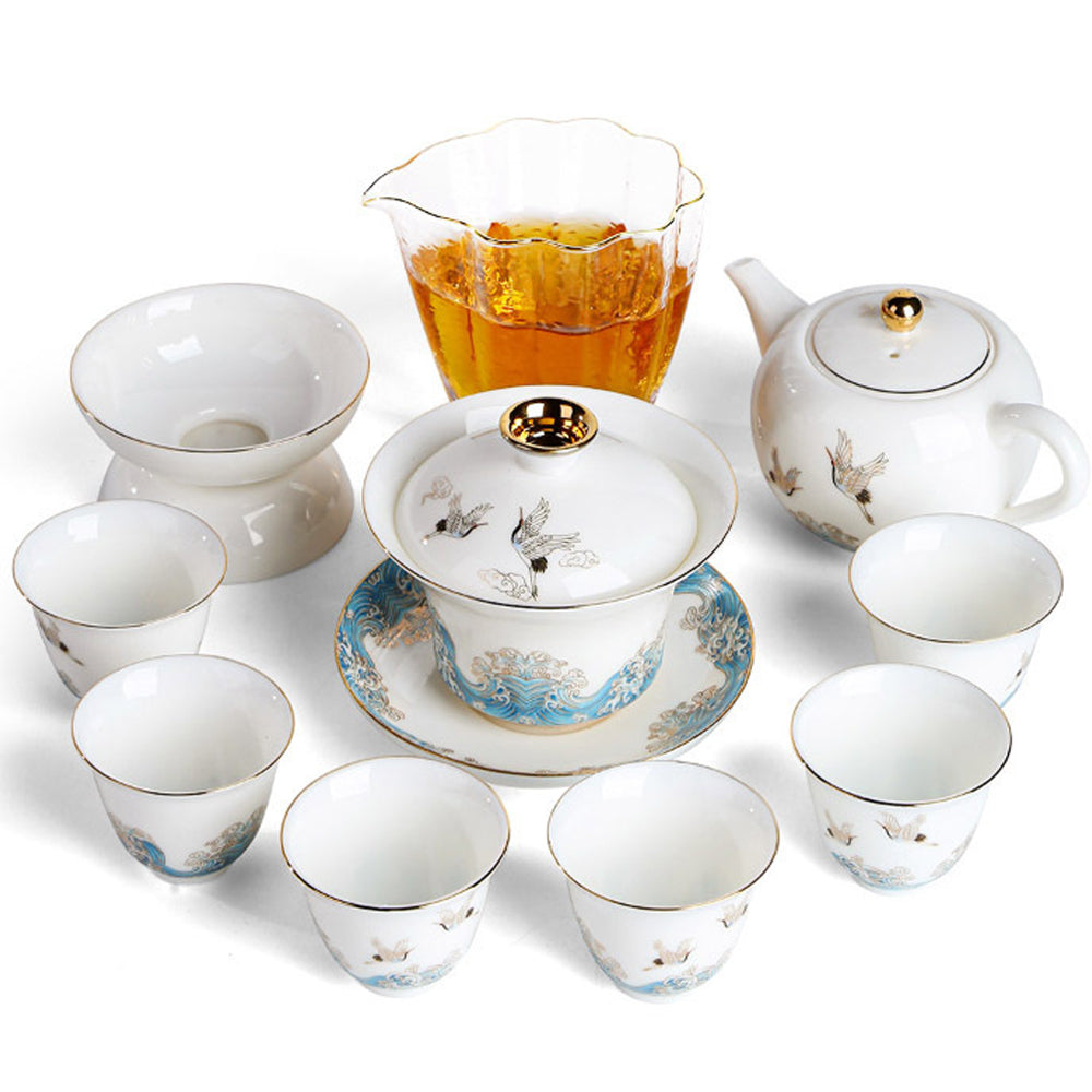 Elegant red-crowned crane ceramic tea set displayed with tea cups and teapot