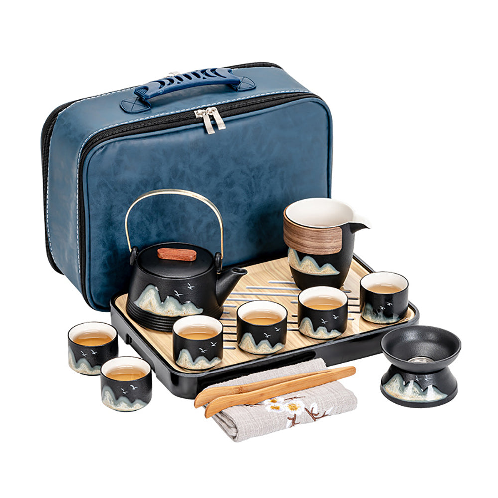 Black pottery travel tea set with mountain design, ideal for on-the-go tea brewing