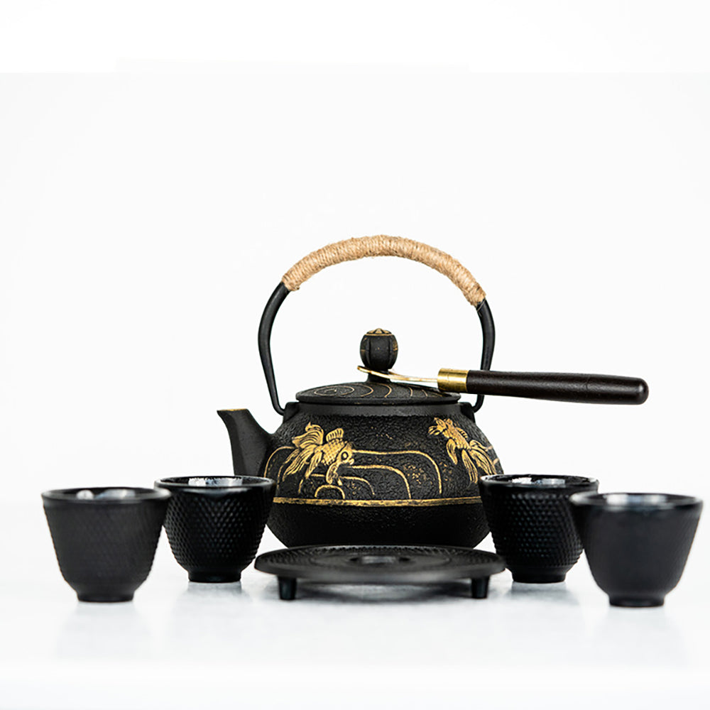 Elegant cast iron goldfish tea pot with intricate design and ripples.