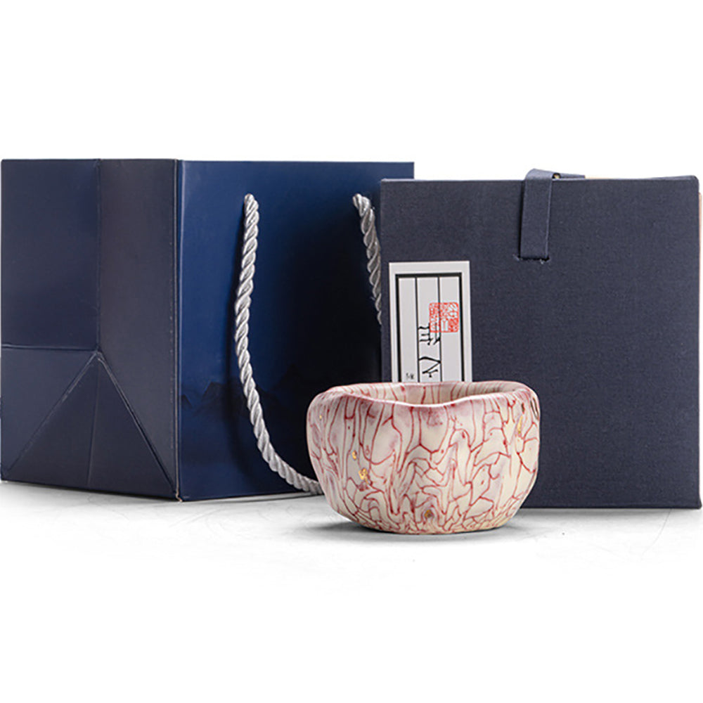 Close-up of pink magma kung fu tea cup with gold accents showing lava crack pattern