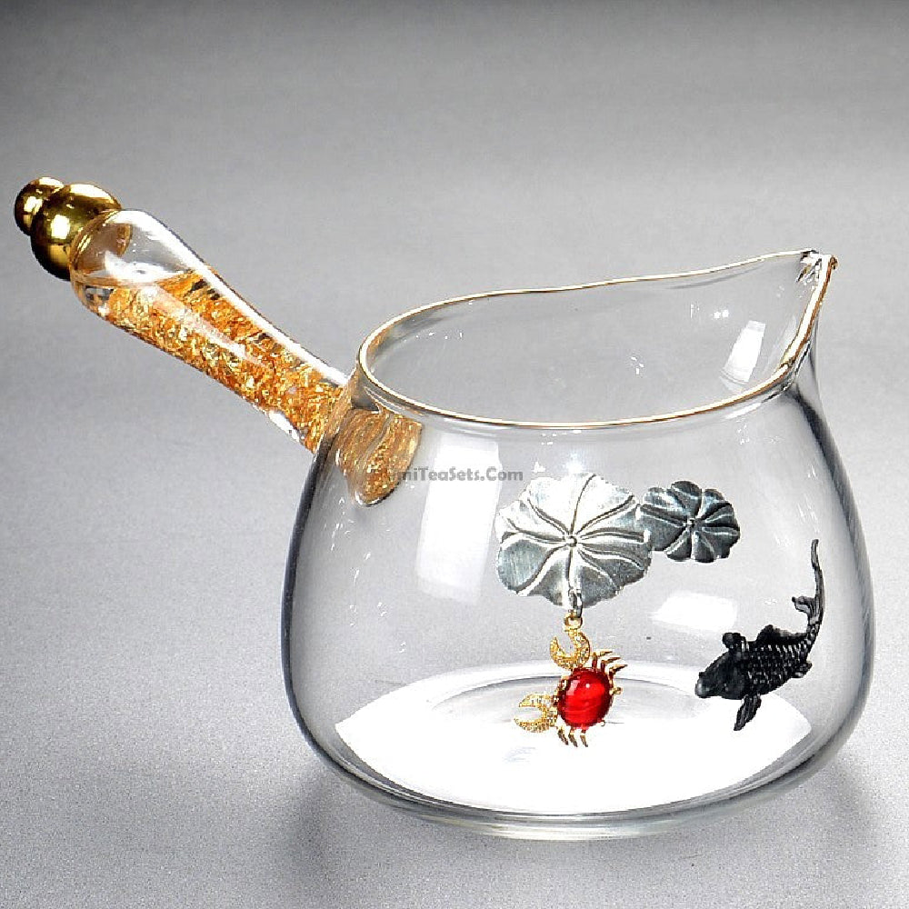 Elegant glass tea cup with golden handle, showcasing its beautiful design