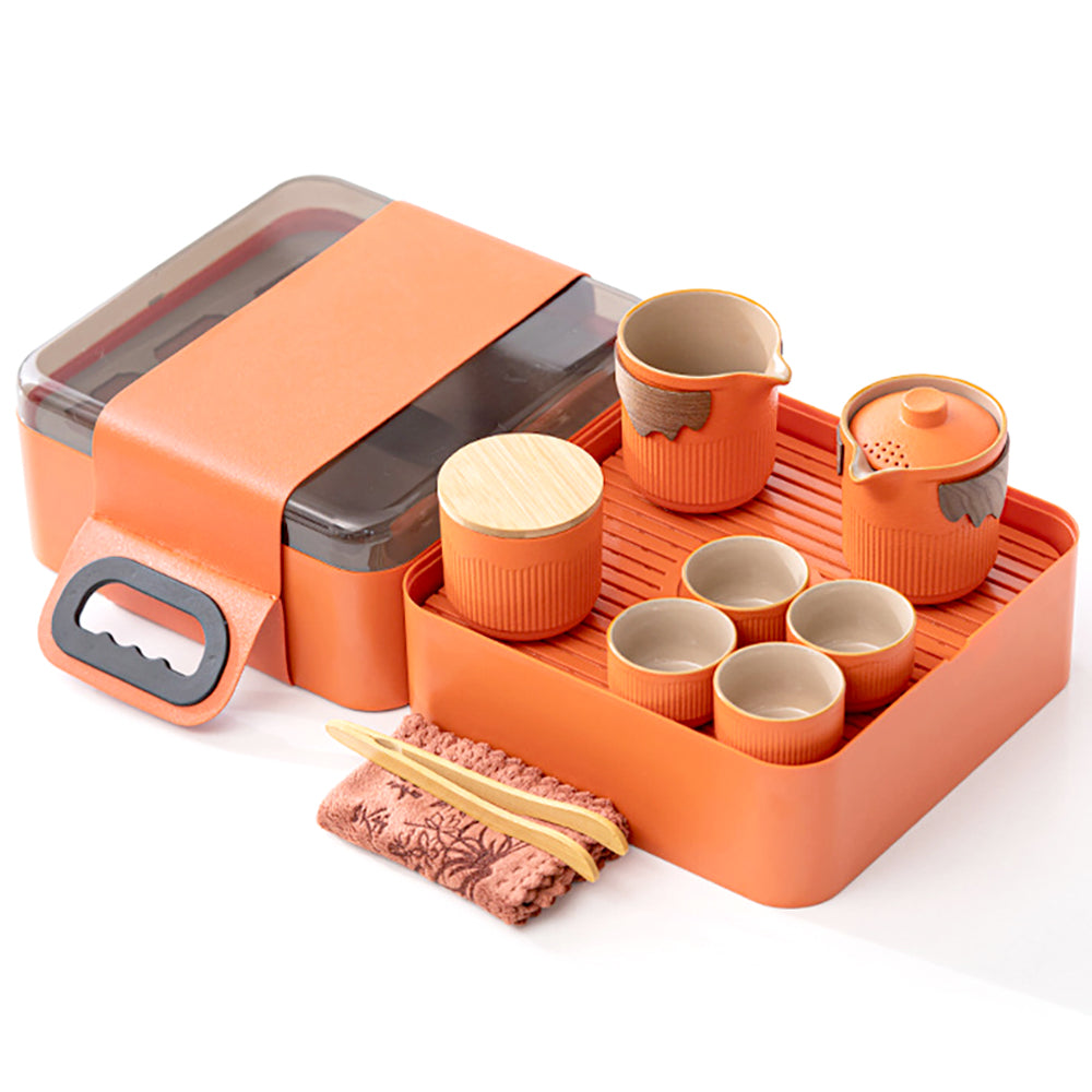 Top-down view of the orange ceramic kung fu tea set displayed on its travel tray outdoors