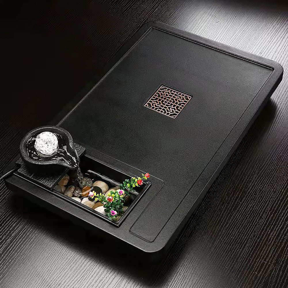 Feng shui tea tray with flowing water and decorative crystal ball