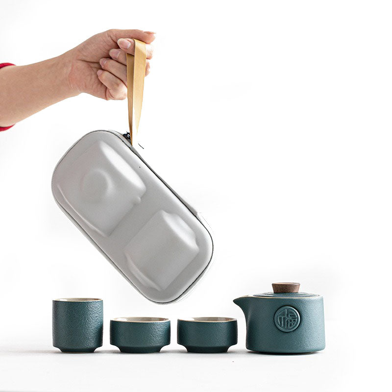 Top view of Lucky Character ceramic travel tea set with teapot and cups arranged neatly in travel bag