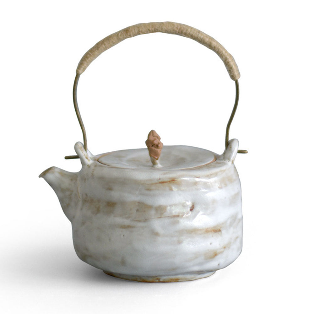 Front view of a handmade Japanese coarse pottery teapot with traditional design