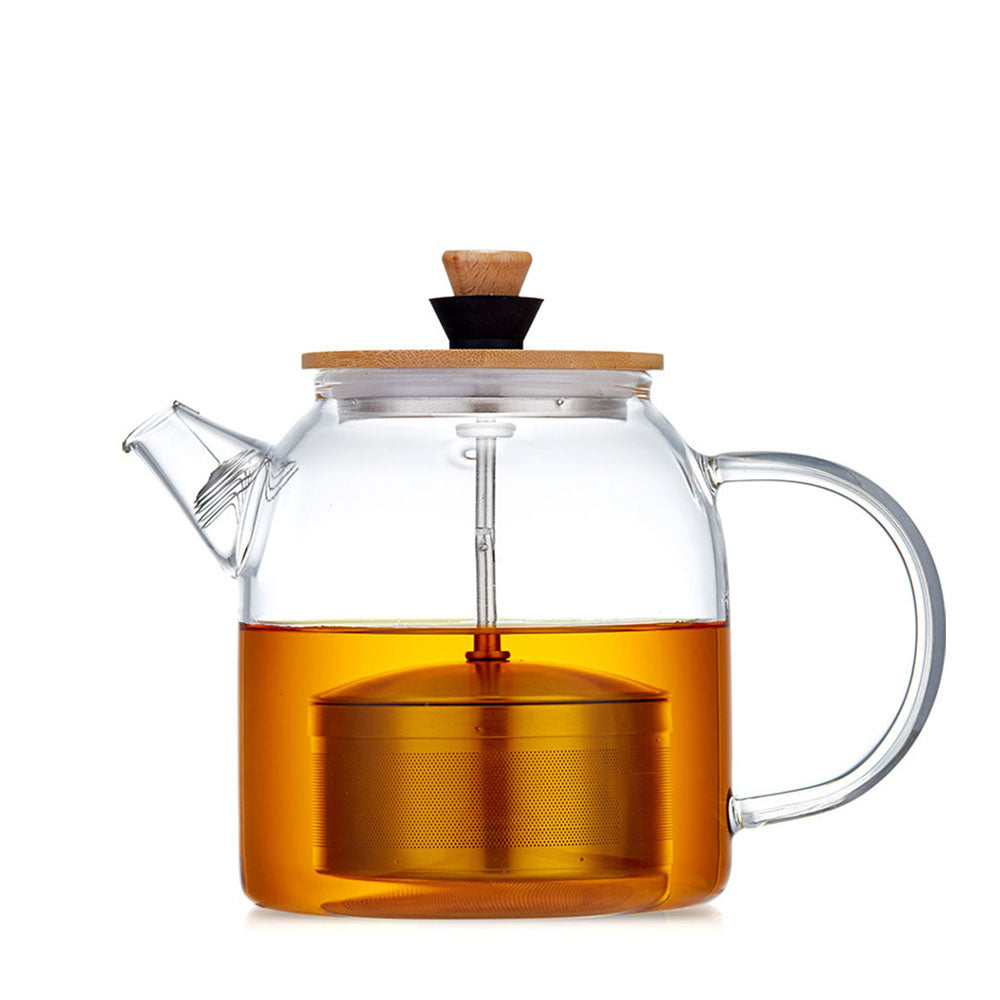 Close-up of the glass teapot with infuser showing tea leaves blooming