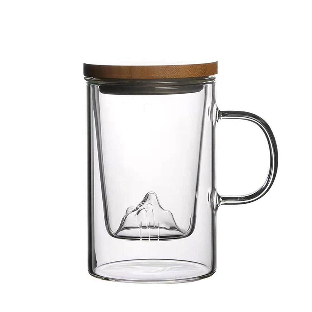 Elegant borosilicate glass tea cup with mountain infuser, perfect for brewing.