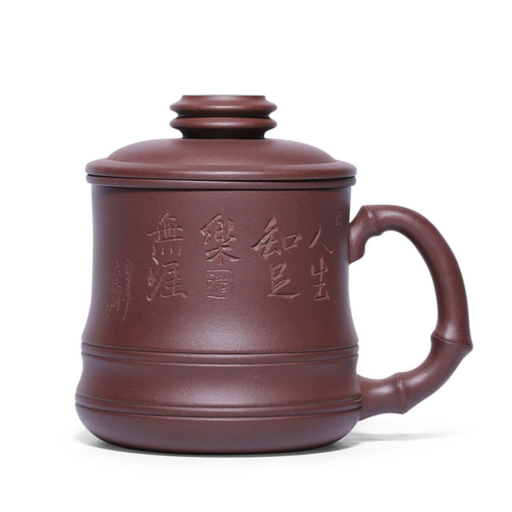 Close-up of purple clay bamboo teacup with infuser showing intricate carvings