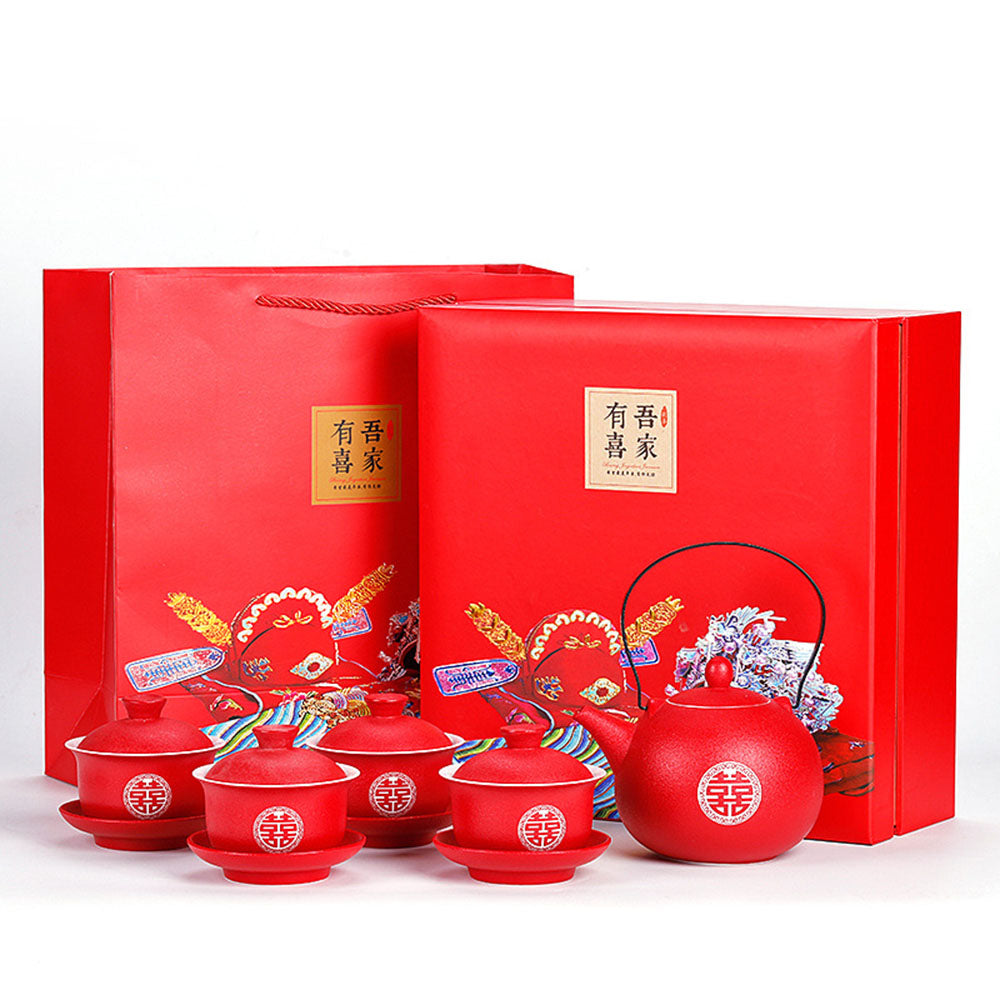 Elegant Double Happiness teapot with four gaiwans, showcasing intricate engravings.