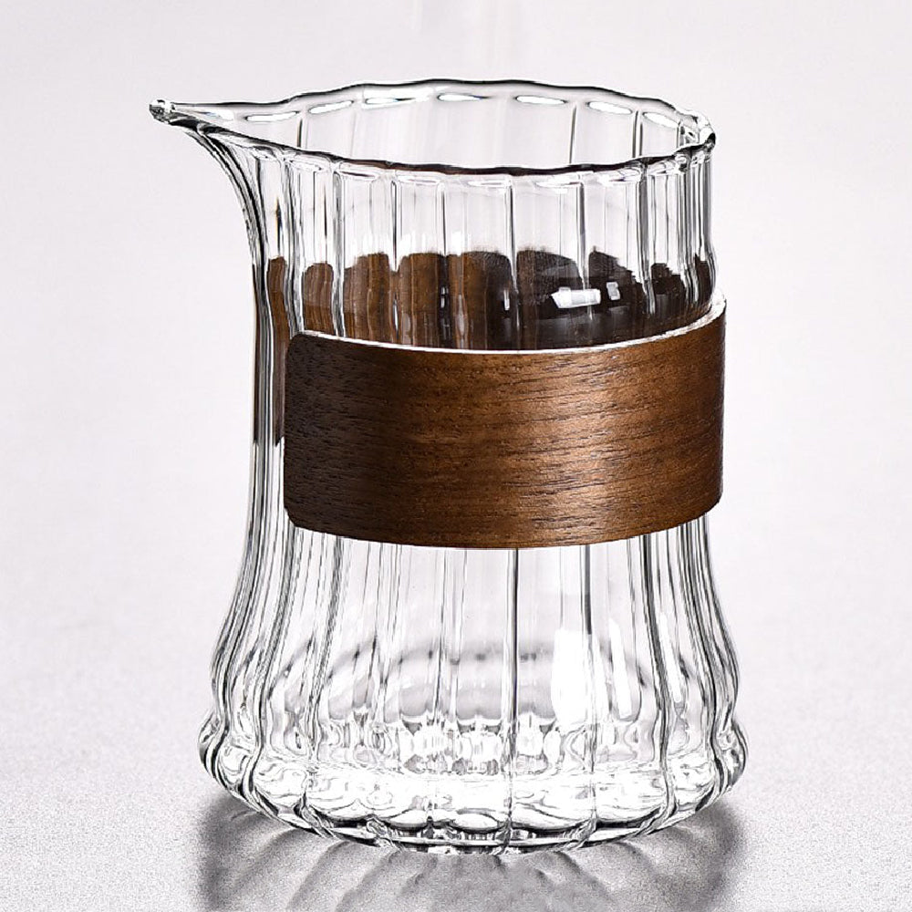 Close-up of the giant striped glass tea mug with bamboo handle, showing its detailed design and size.