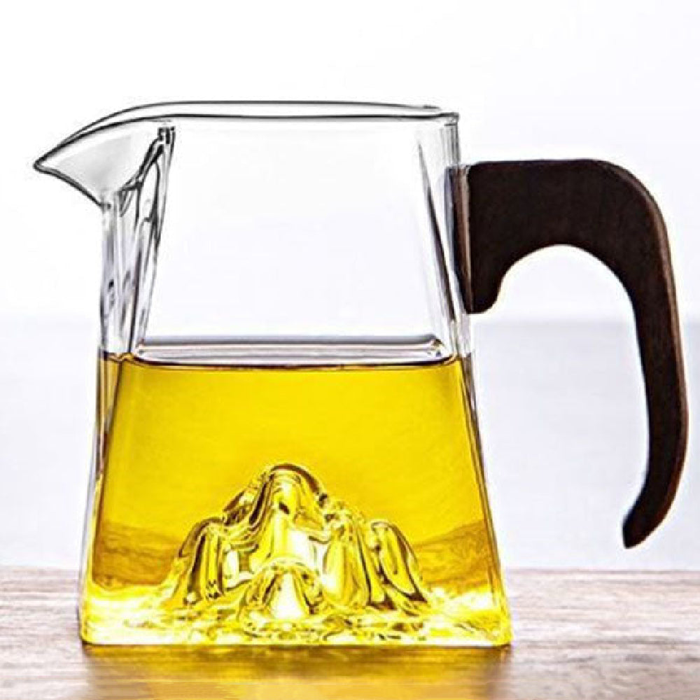 Large glass tea cup with wooden handle from a top view, ideal for daily tea brewing