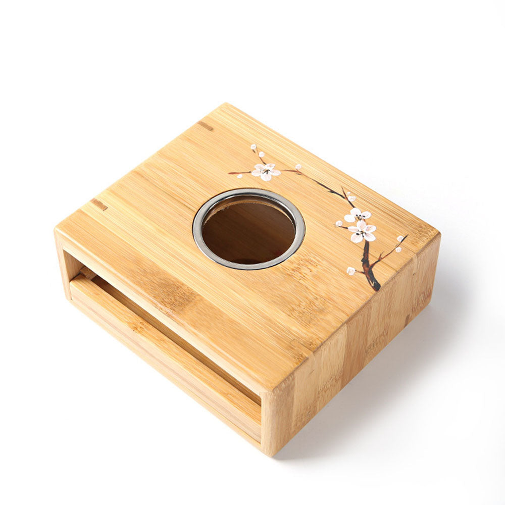 Close-up of bamboo candle teapot warmer with tea pot on top, showcasing natural bamboo finish
