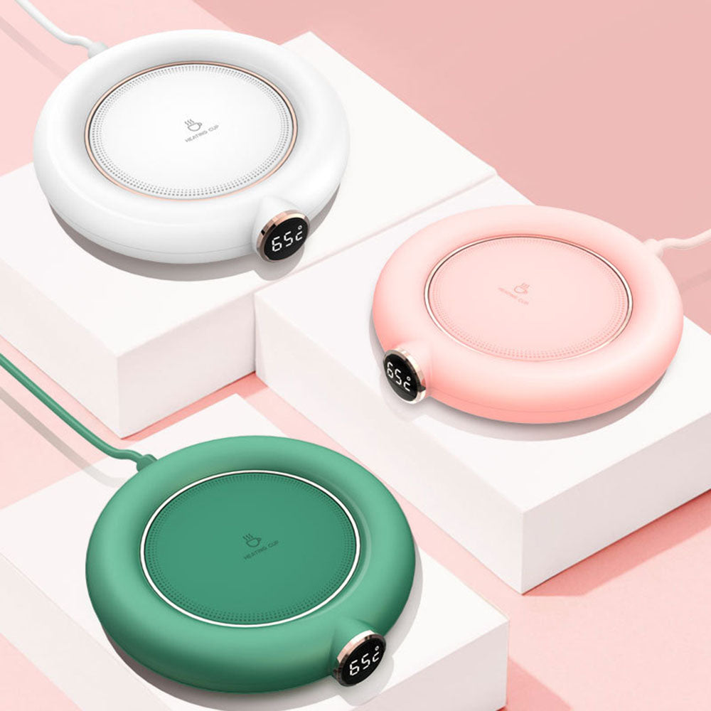 Close-up of ceramic USB teapot warmer with tea pot on top, stylish and modern design