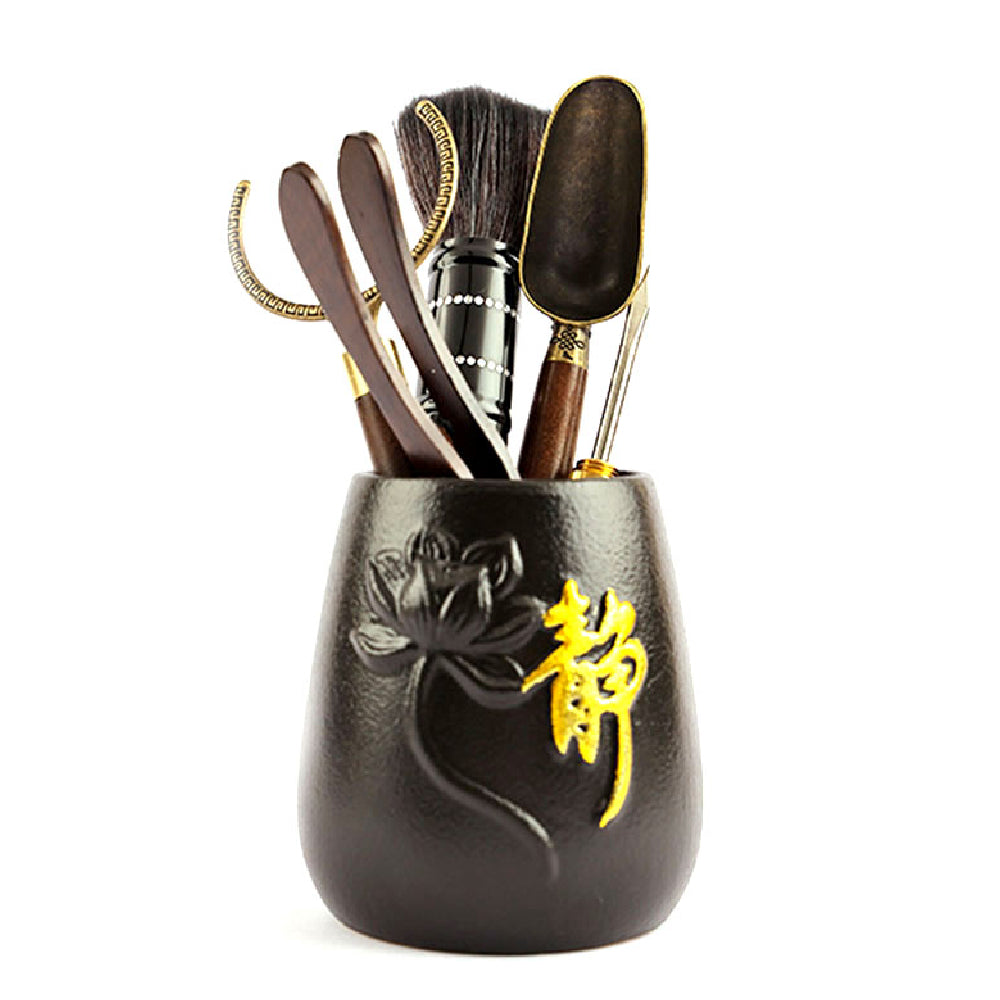 Elegant ebony tea utensils set displayed with a ceramic lotus holder, showcasing all six tools for the gongfu tea ceremony.