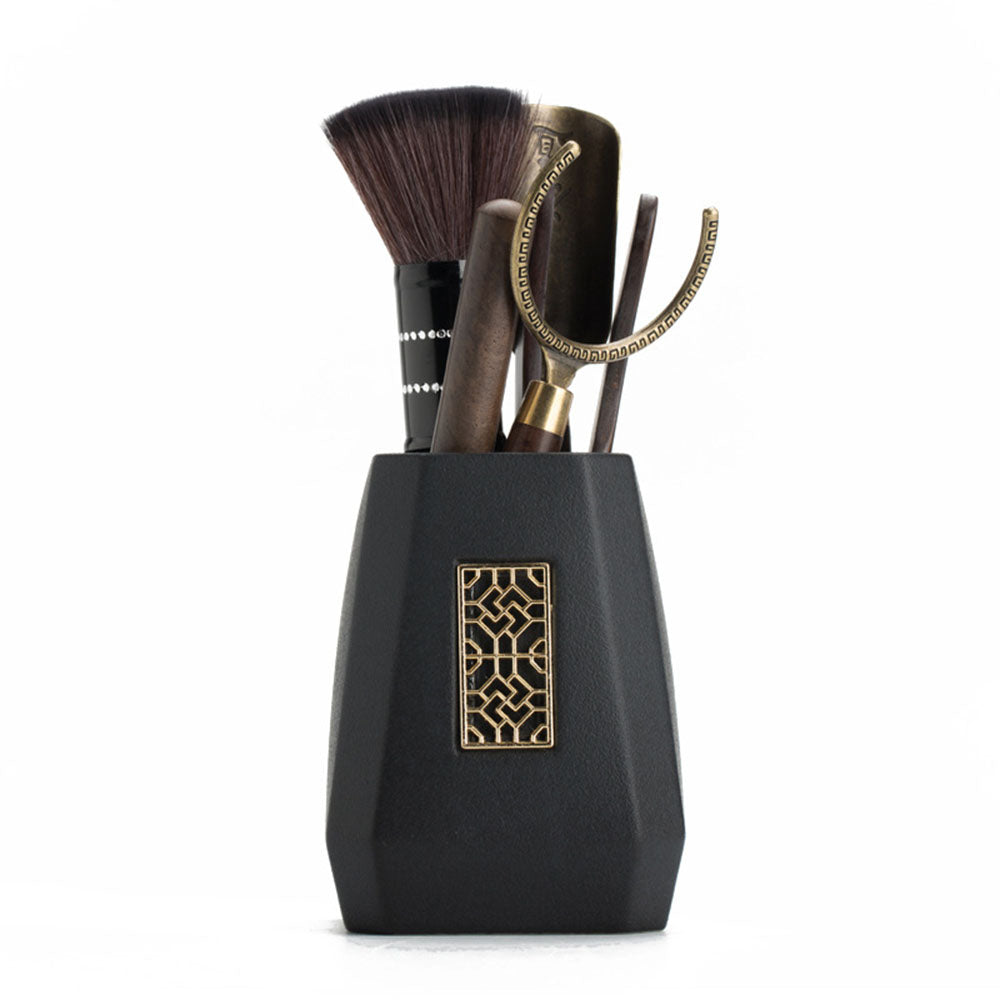 Ebony tea utensils set displayed on a traditional tea table, showcasing the black ceramic holder.