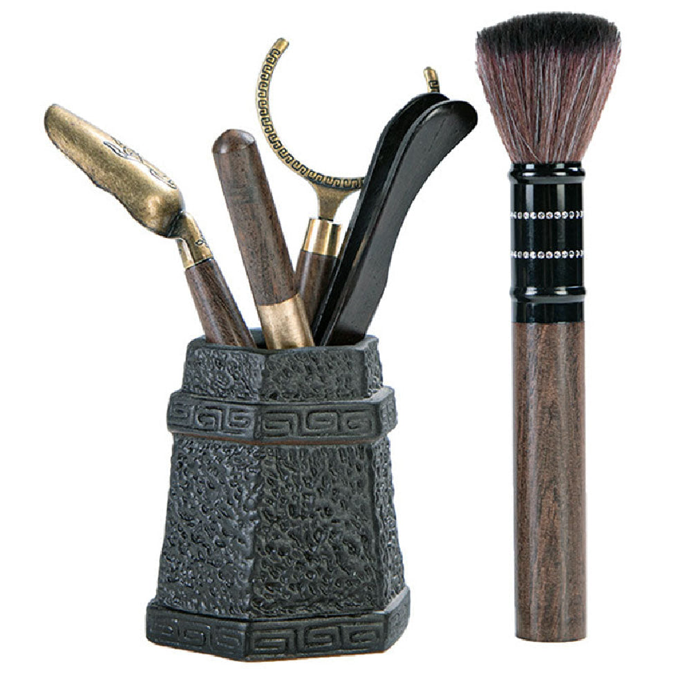 Close-up of ebony tea utensils set with stone holder, showcasing craftsmanship