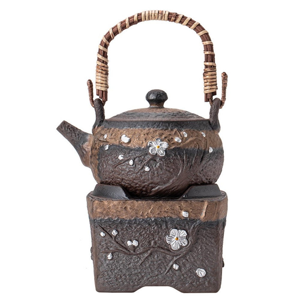 Close-up of vintage style plum blossom rock clay teapot warmer showing textured surface