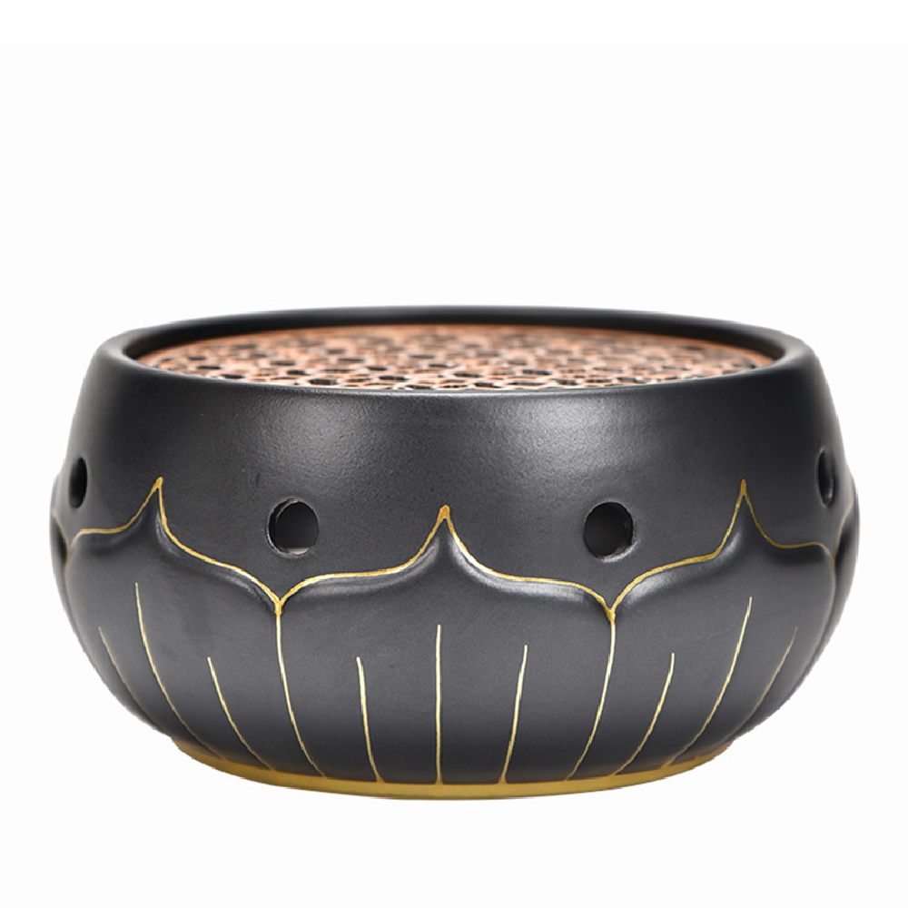 Close-up of black ceramic lotus teapot warmer with gold accents