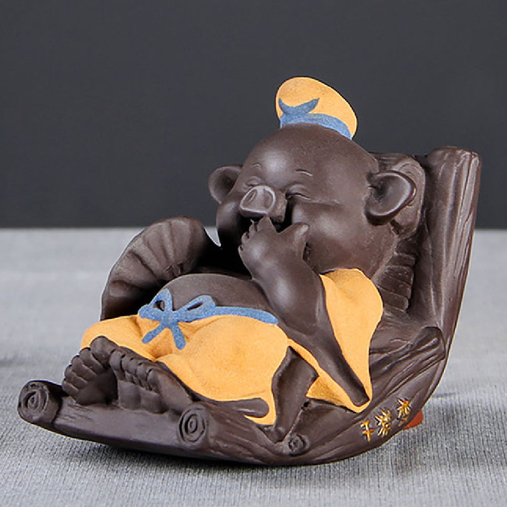 Close-up of hand-painted Yixing clay Zhu Bajie pig tea pet on a tea tray