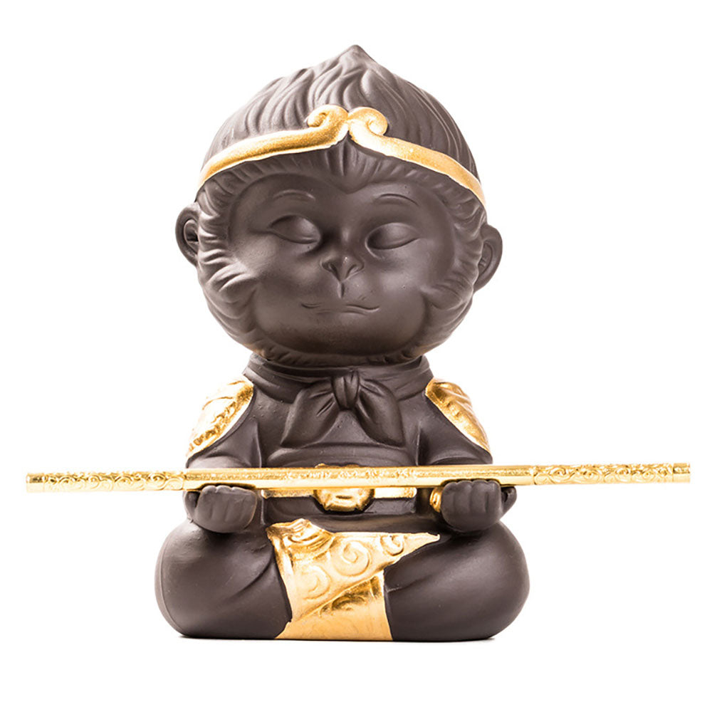 Handcrafted purple clay Wukong tea pet with detailed carving on a tea tray