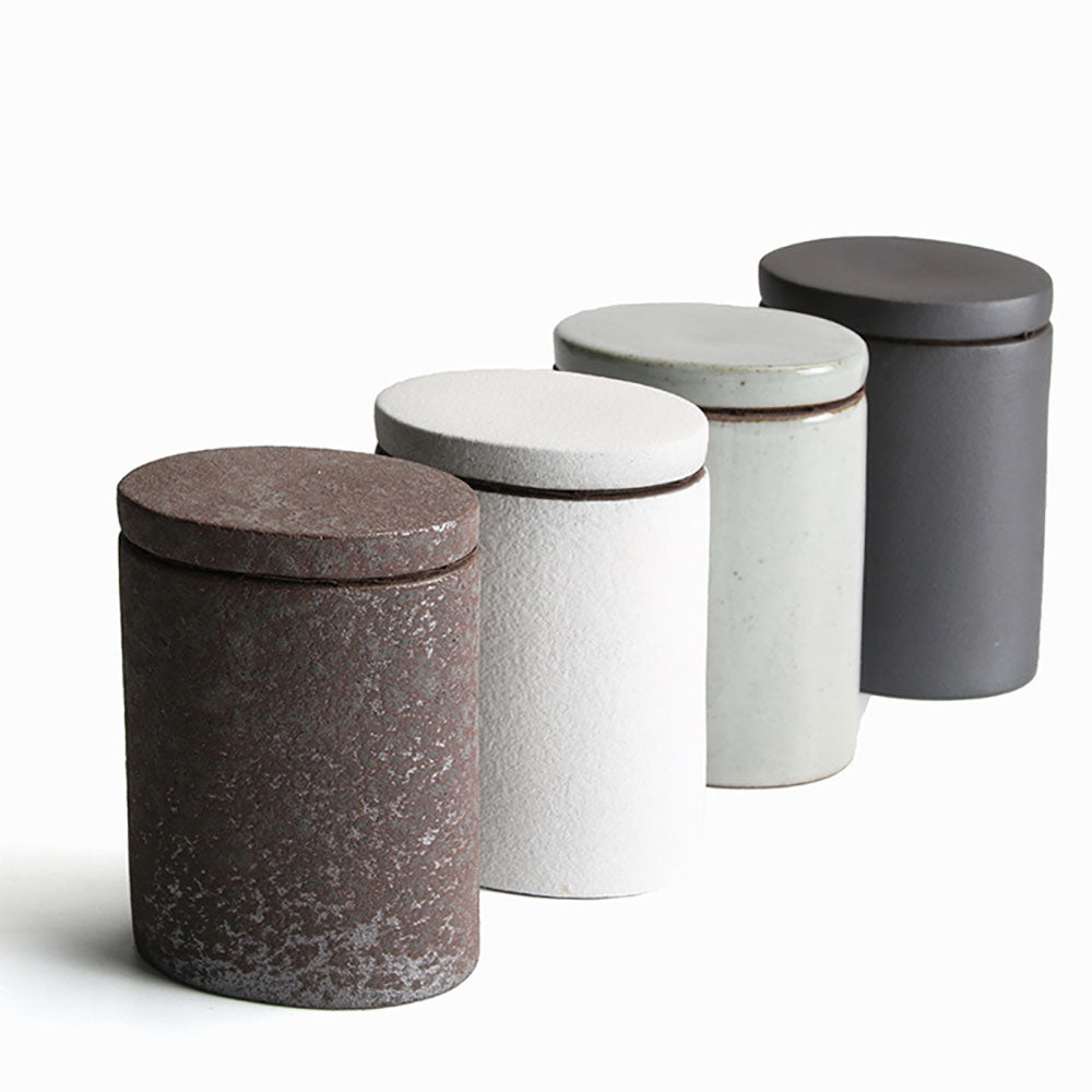 Close-up of the four pottery tea caddies showing their sleek design and airtight lids