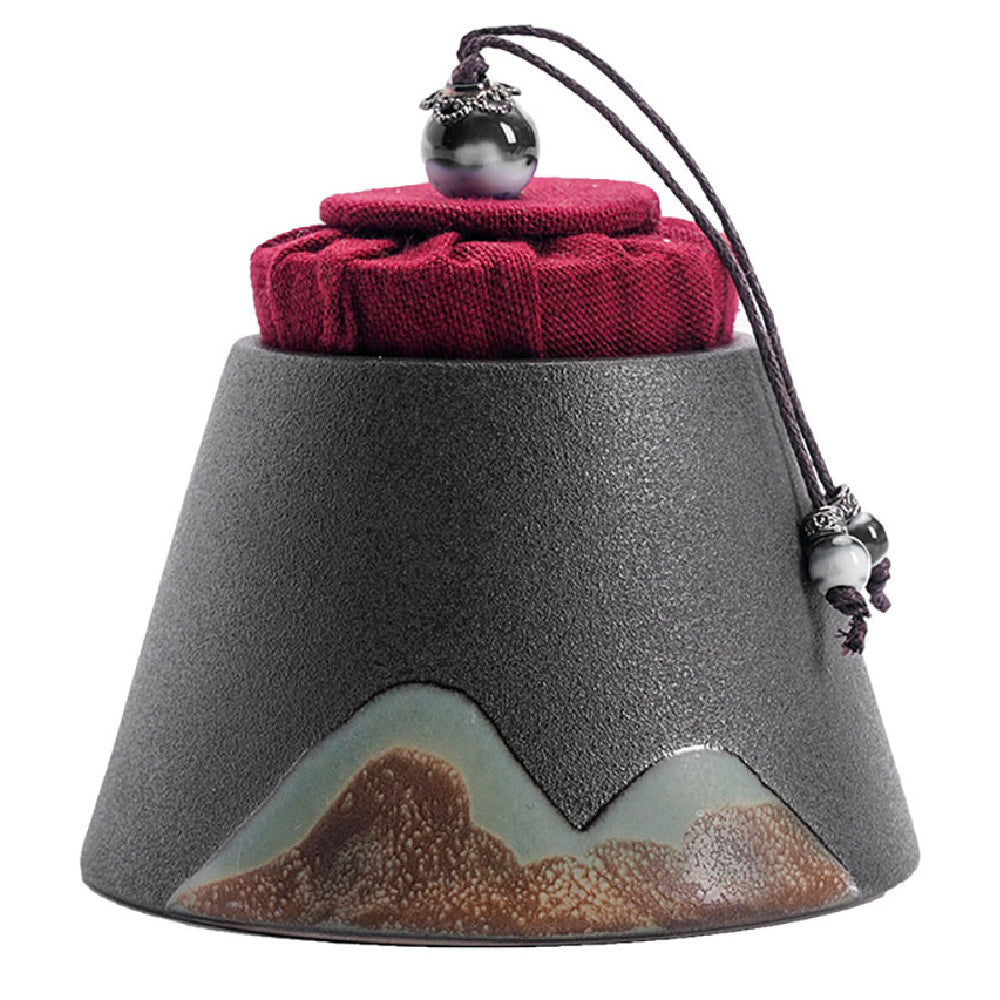 Mountain-Style Japanese Ceramic Tea Caddy from a side angle, showcasing its elegant shape and texture.