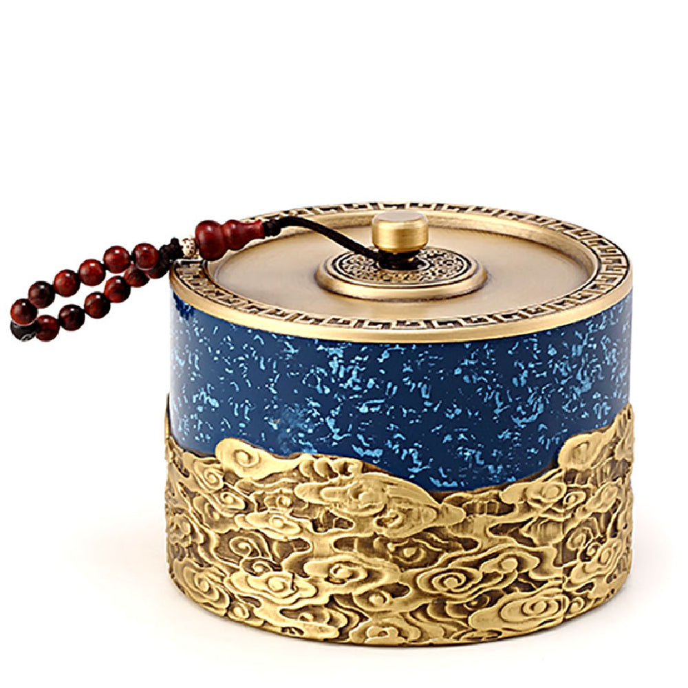Close-up of auspicious cloud carvings on copper tea caddy