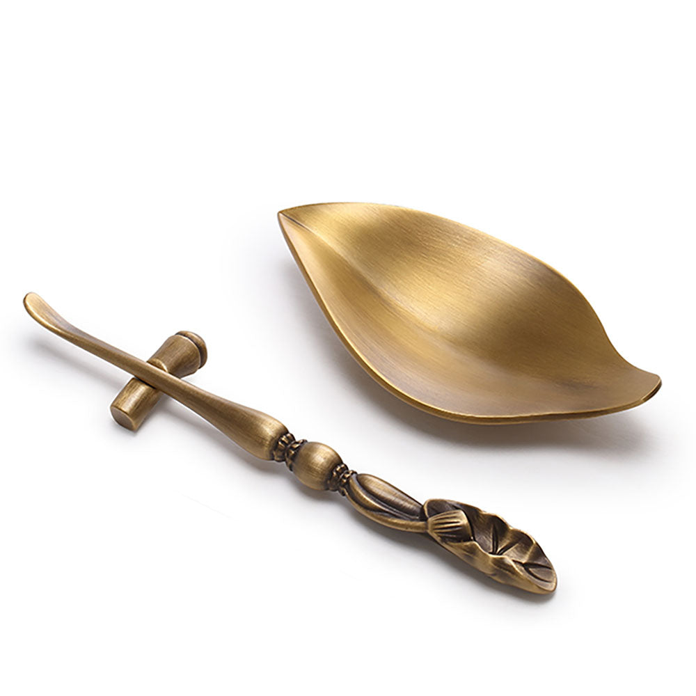 Artisan brass tea holder showcasing dry tea leaves during a tea ceremony.