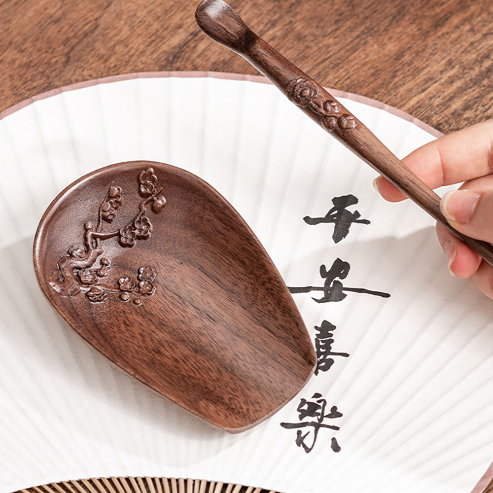 Close-up of walnut wood tea holder with tea needle showing detailed craftsmanship
