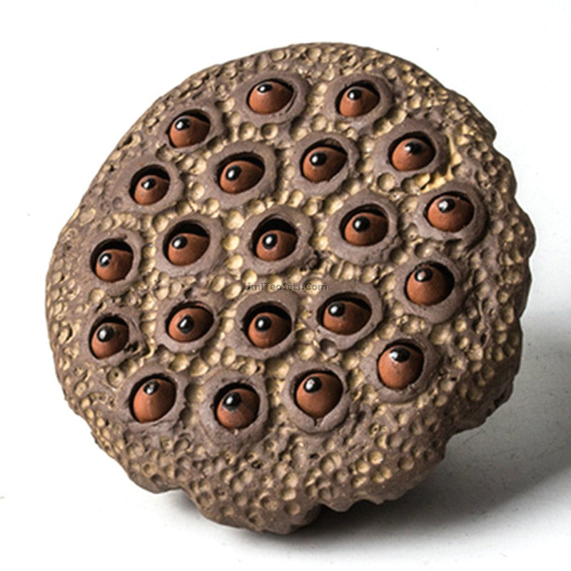 Artisan purple clay lotus seedpod tea pet from the side, showcasing its unique design.