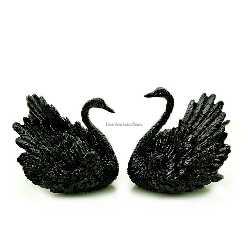 Elegant swan tea pet set displayed on a traditional tea tray.