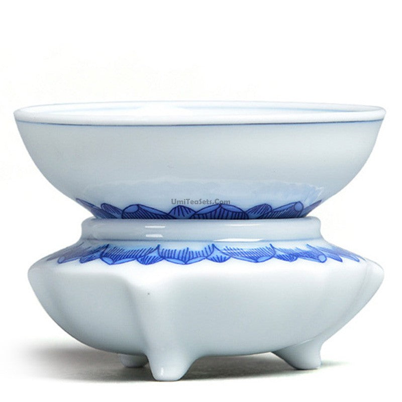 White porcelain tea strainer with holder on a tea table, close-up view