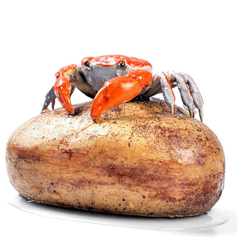 Color changeable crab tea pet displayed on a tea tray, showcasing its intricate design.