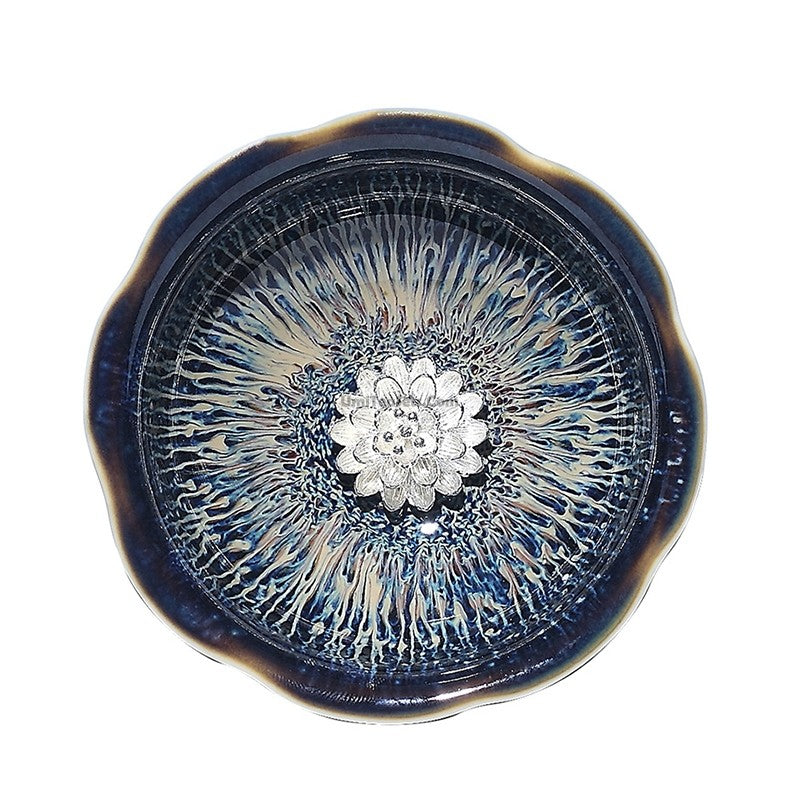 Close-up view of Artisan Jianzhan Gongfu tea cup showcasing sterling silver lining.