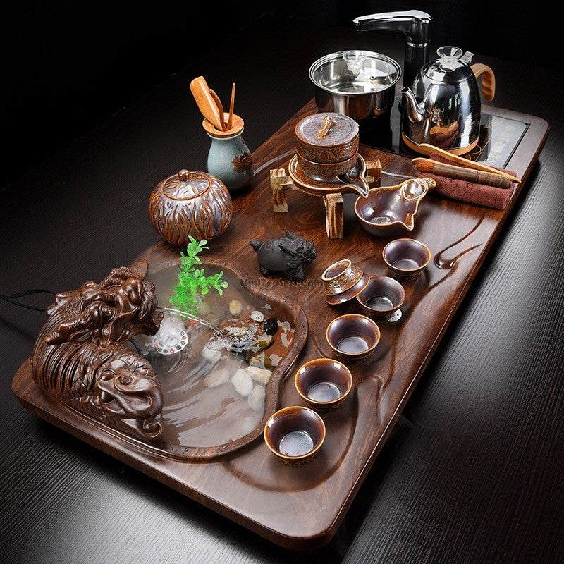 Close-up of the Jun Kiln automatic tea set with fish pond tea tray and accessories, showcasing craftsmanship and design details.
