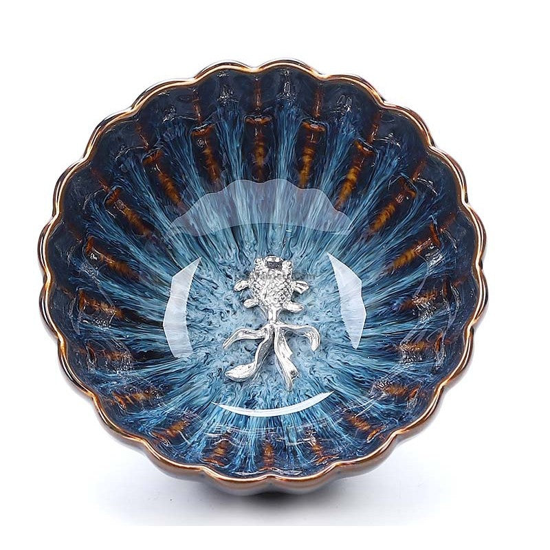 Handmade blue jianzhan gongfu tea cup with sterling silver lid, showcasing detailed craftsmanship