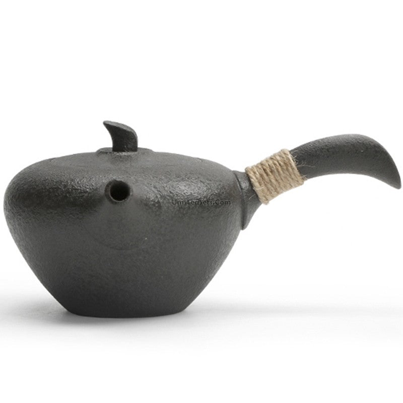 Elegant black pottery Japanese teapot with a side handle and leaf-shaped lid.