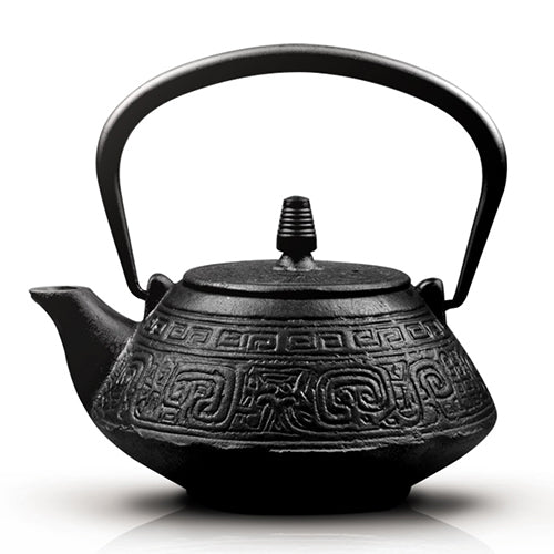 Close-up of carved auspicious symbols on Japanese cast iron teapot